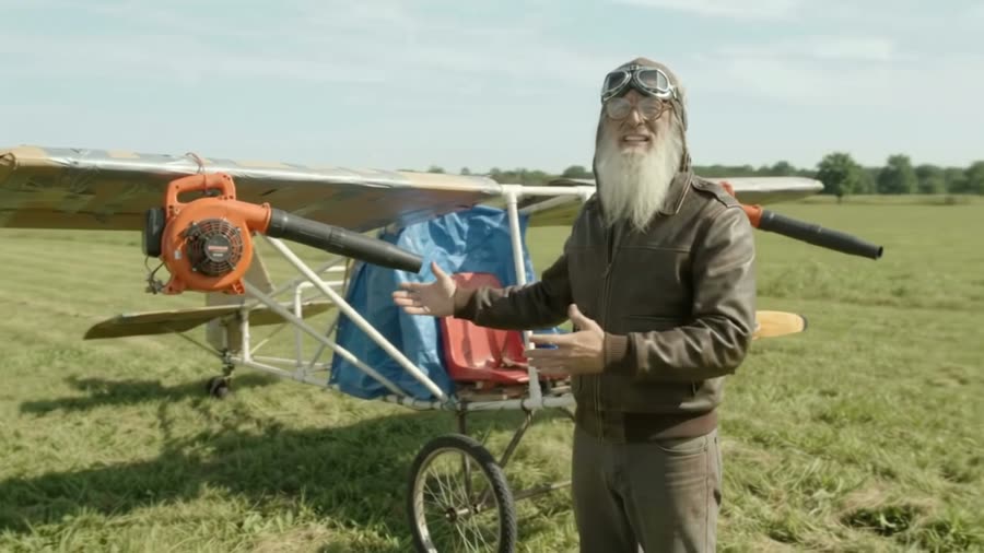 The pilot, now much older, shows off his latest rebuilt plane